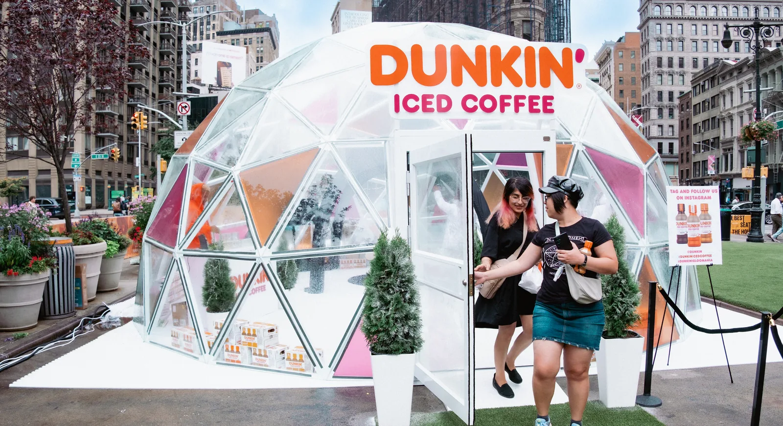 Consumers leaving a Dunkin' Iced Coffee igloo during a Green House experiential activation in New York's Flatiron District.