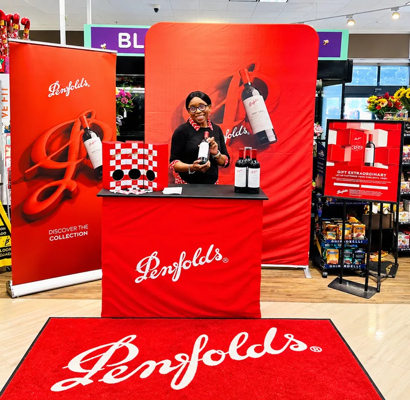 Green House brand ambassador hosting a Penfolds in-store retail activation with a premium gifting display.